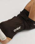 Model wearing Cuera Oncourt Slim Tank Top in Dark Brown, close-up detail on model