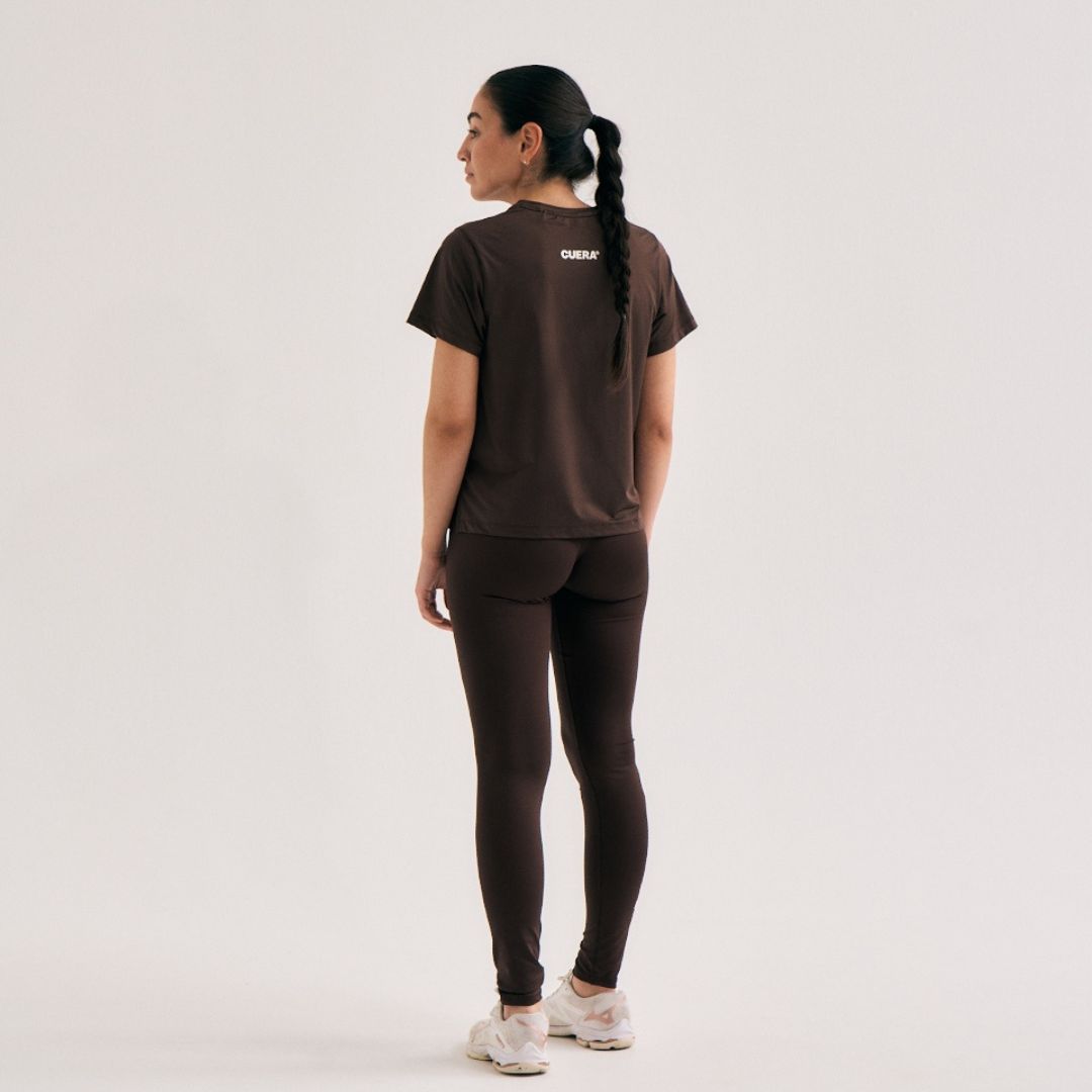 Model wearing Cuera Oncourt Slit Top SS in Dark Brown, back studio view