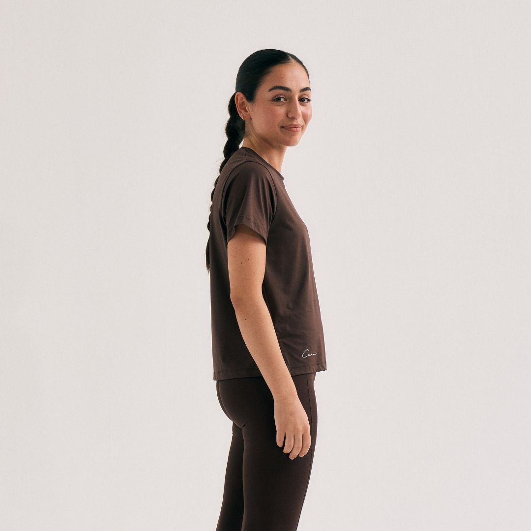 Model wearing Cuera Oncourt Slit Top SS in Dark Brown, front studio view