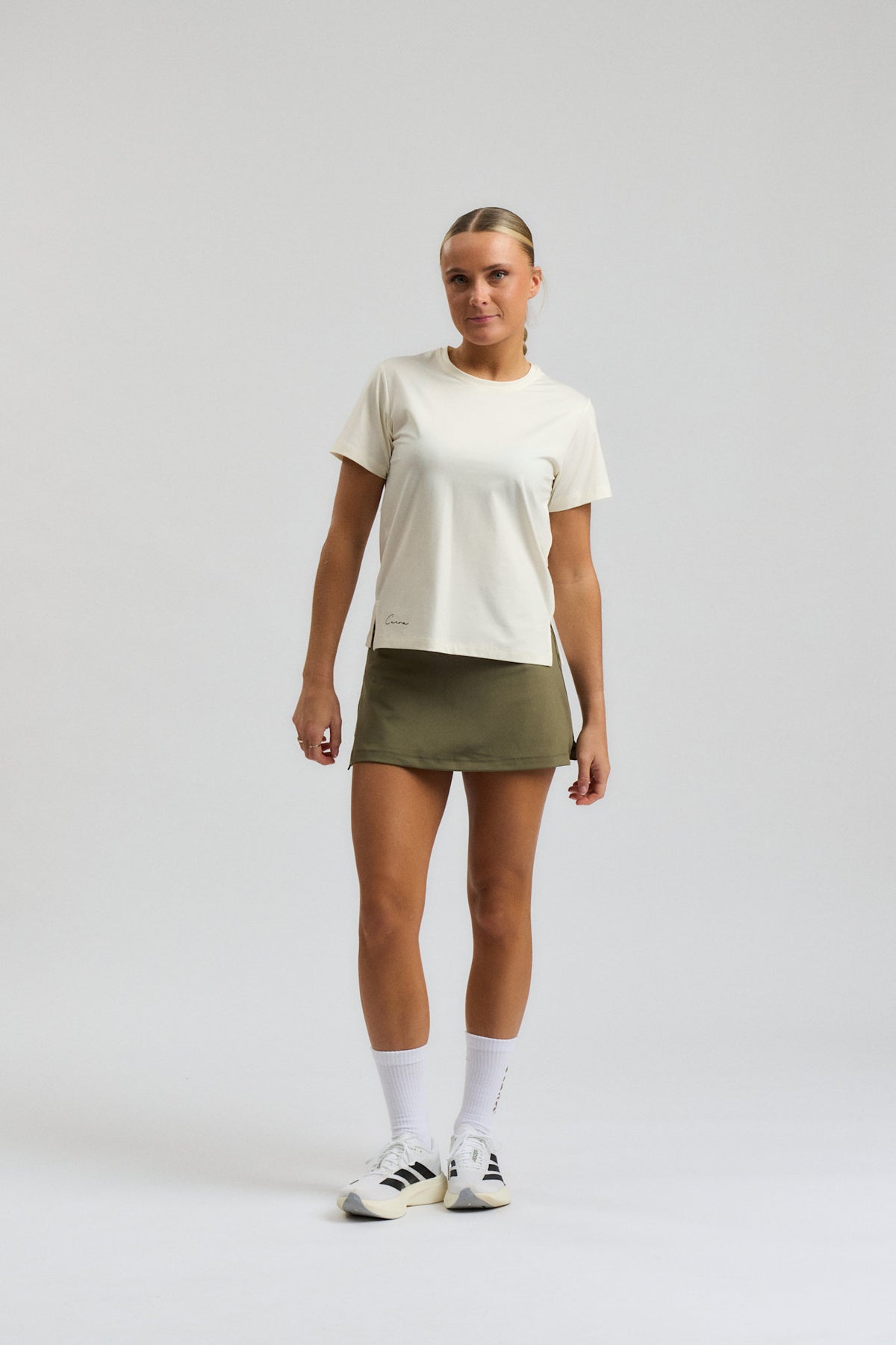 Model wearing Cuera Oncourt Slit Top SS in Off White, front studio view