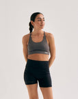 Model wearing Cuera Oncourt Soft Bra Top in Dark Grey, front studio view